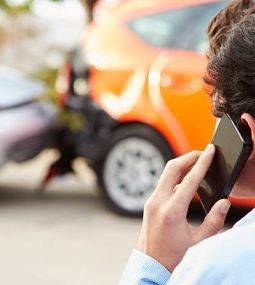Teenage Driver Making Phone Call After Traffic Accident Shot From Behind.